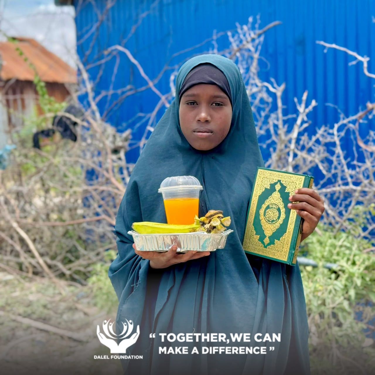 A girl in a green headscarf holding her Qur'an in one hand and a tray of food and juice in the other